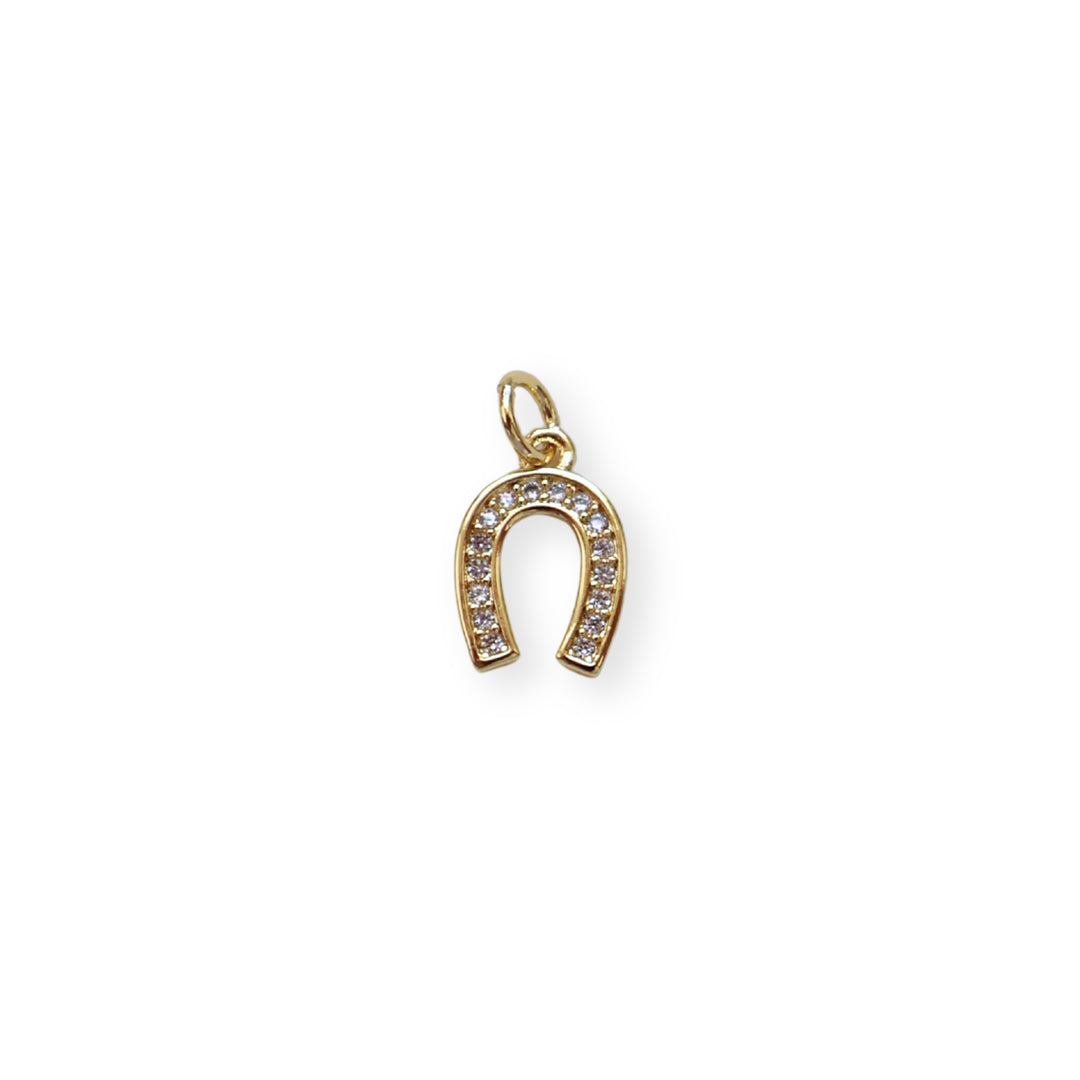 Dije dorado en forma de herradura de caballo con zirconias