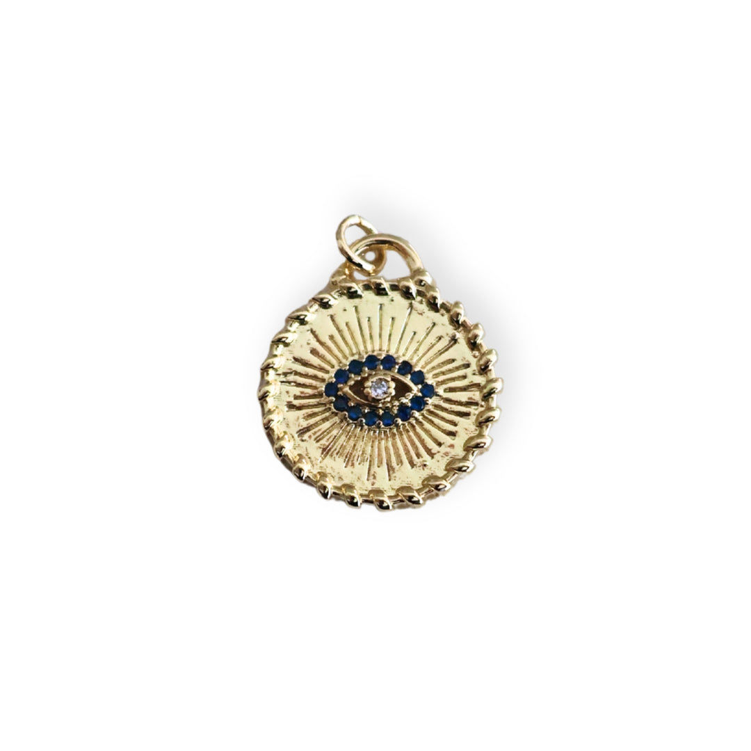 Dije circular dorado con ojo turco y zirconias en chapa de oro