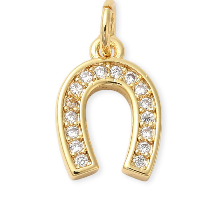 Dije dorado en forma de herradura de caballo con zirconias
