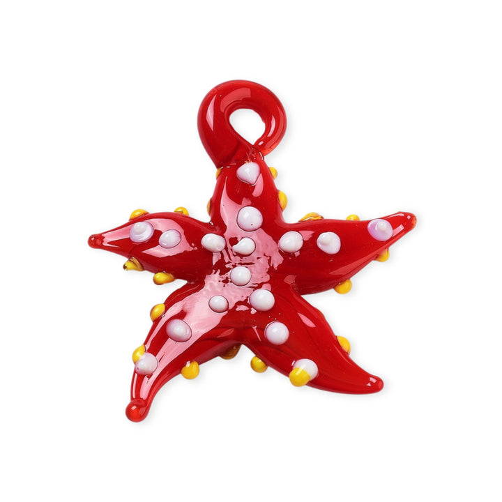 Dije de murano en forma de estrella de mar, color rojo con puntos blancos y amarillos