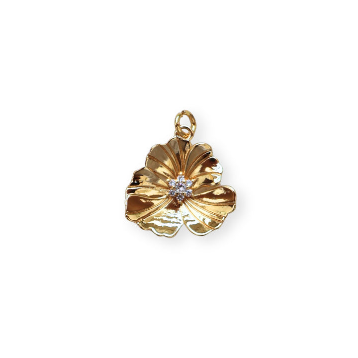Dije flor dorada en chapa de oro con zirconia en el centro