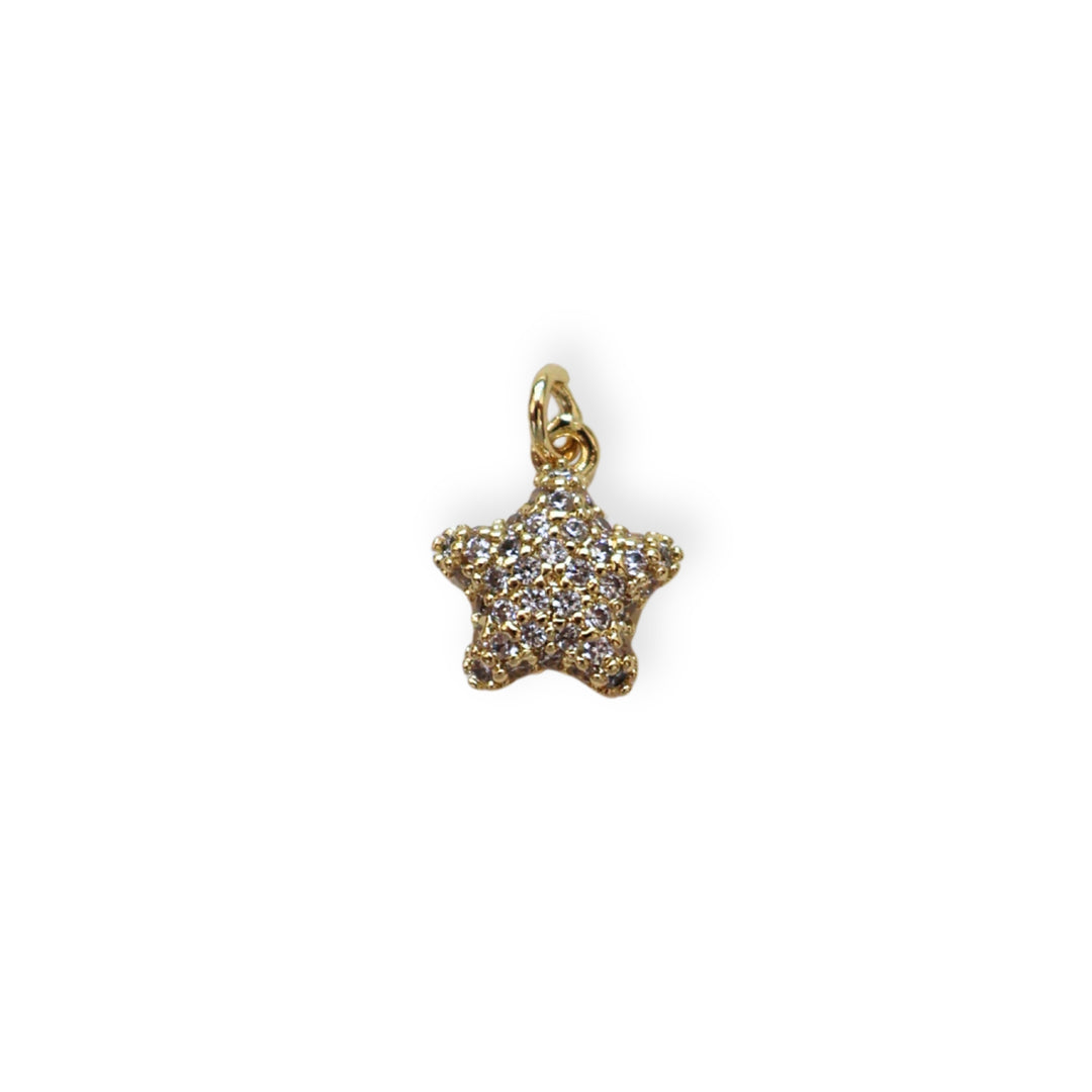 Dije dorado en forma de estrella con zirconia