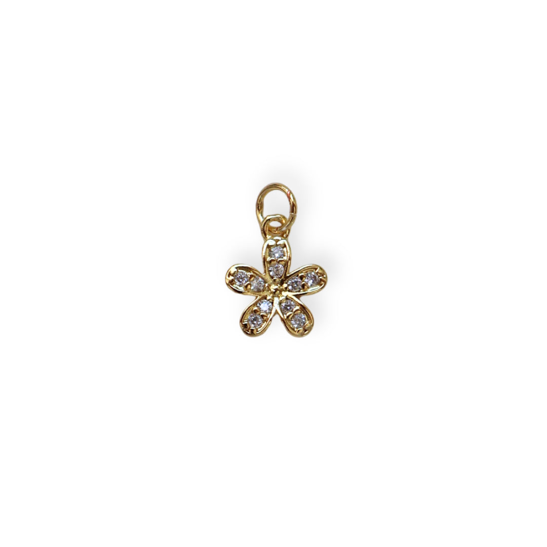 Dije flor dorada en chapa de oro con zirconia en el centro
