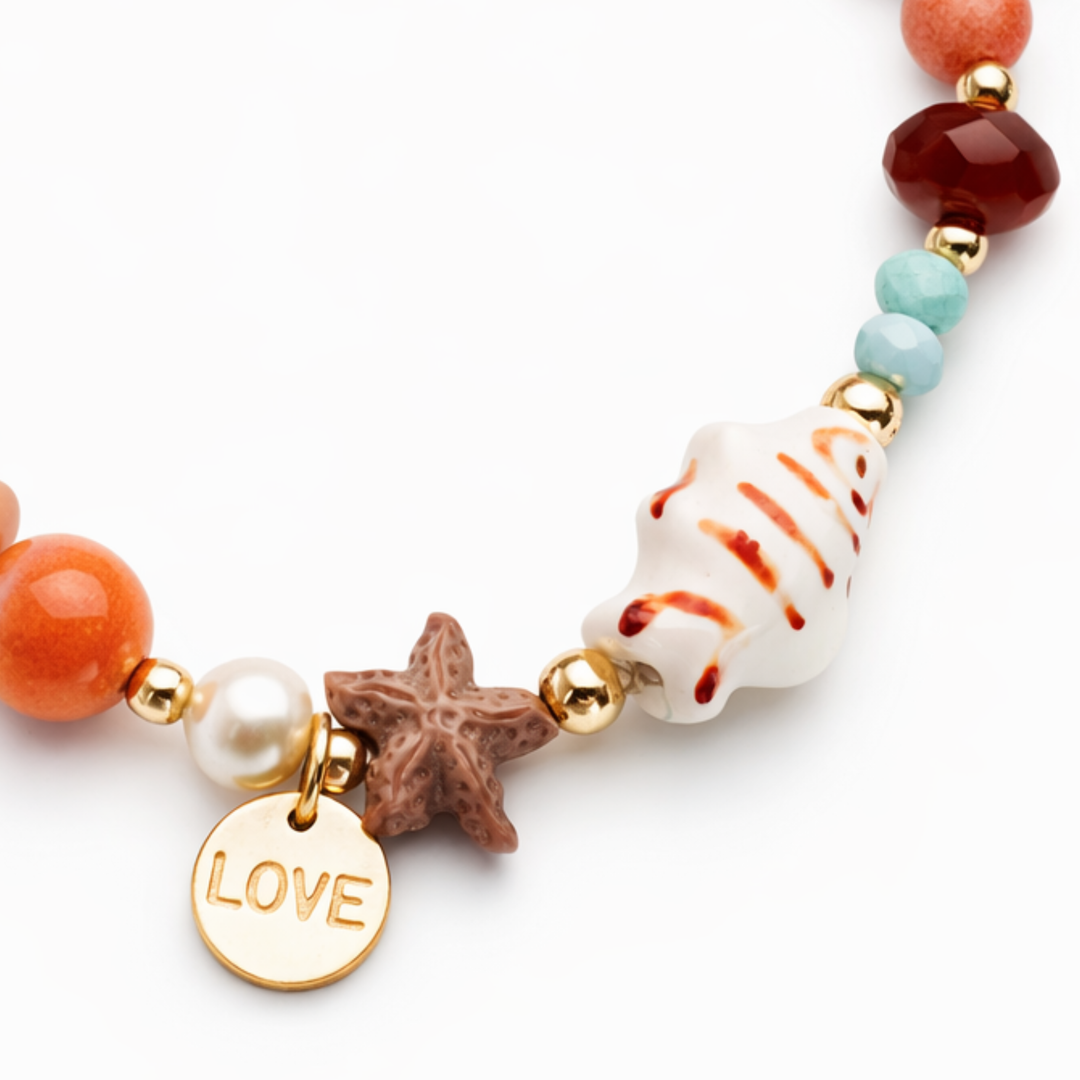 Brazalete marino con pez de cerámica, piedras naturales, perla de río y dije Love de chapa de oro