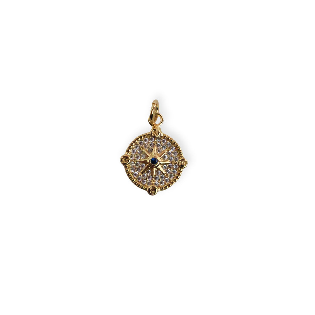 Dije circular dorado con estrella al centro y zirconia