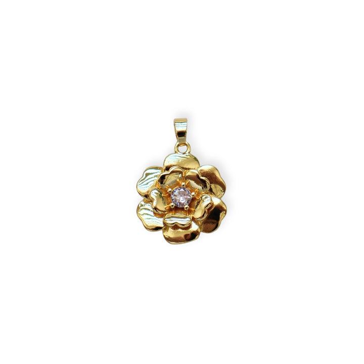 Dije dorado en forma de flor con zirconia al centro
