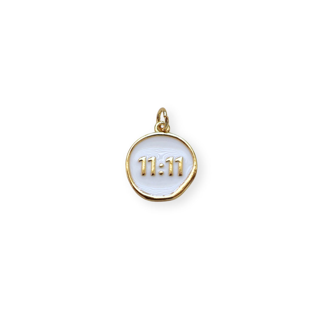 Dije circular dorado con “11:11” esmaltado en blanco