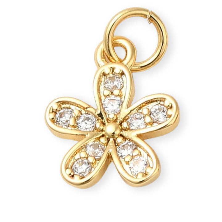 Dije flor dorada en chapa de oro con zirconia en el centro