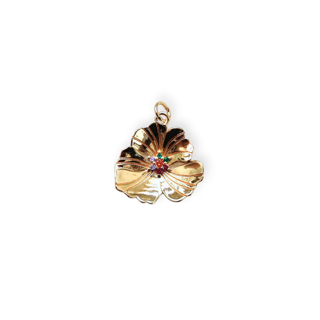 Dije en forma de flor dorada con zirconias multicolor en el centro