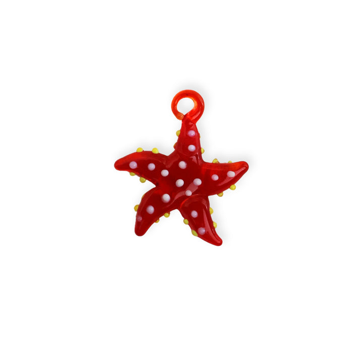 Dije de murano en forma de estrella de mar, color rojo con puntos blancos y amarillos