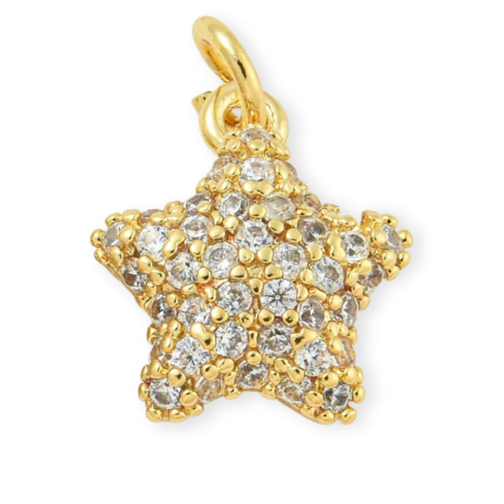 Dije dorado en forma de estrella con zirconia