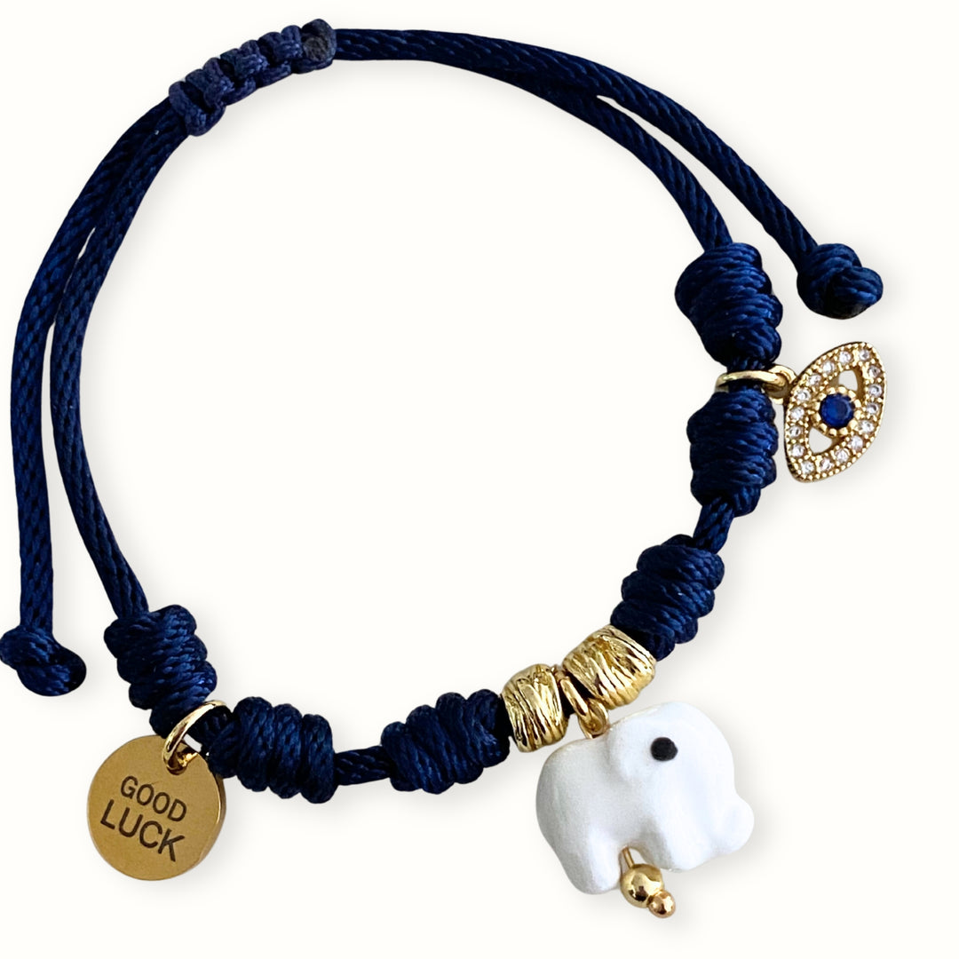 Pulsera ajustable con cordón trenzado y dijes de ojo con zirconia y elefante.