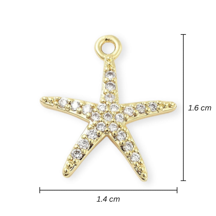 Medidas para Dije estrella de mar en chapa de oro con zirconias alrededor sobre fondo blanco