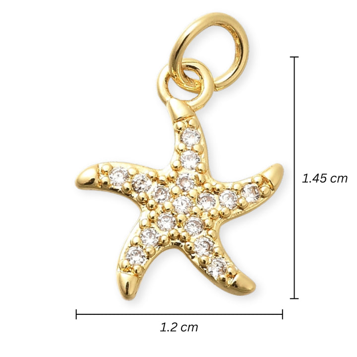 Medidas para Dije de estrella de mar en chapa de oro con zirconias alrededor sobre fondo blanco