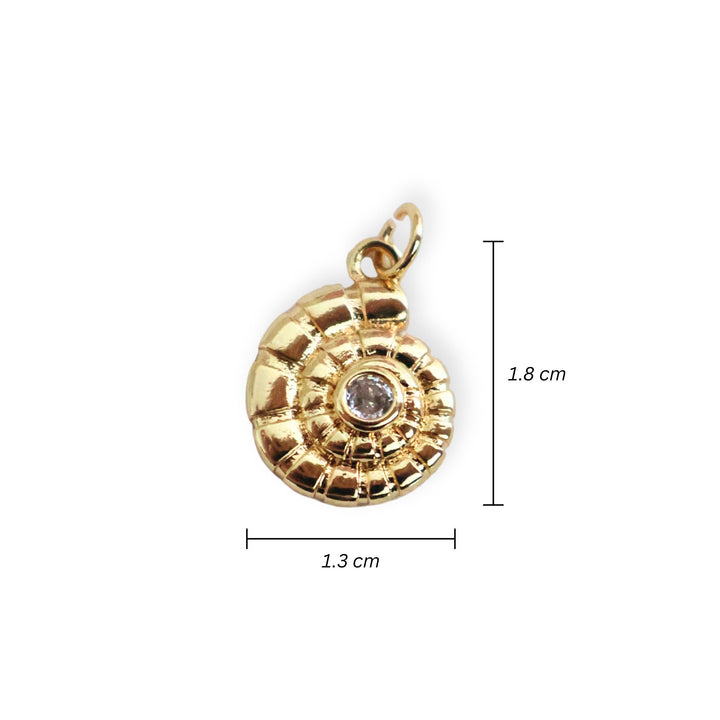 Medidas para dije de caracol en chapa de oro con zirconia al centro sobre fondo blanco.
