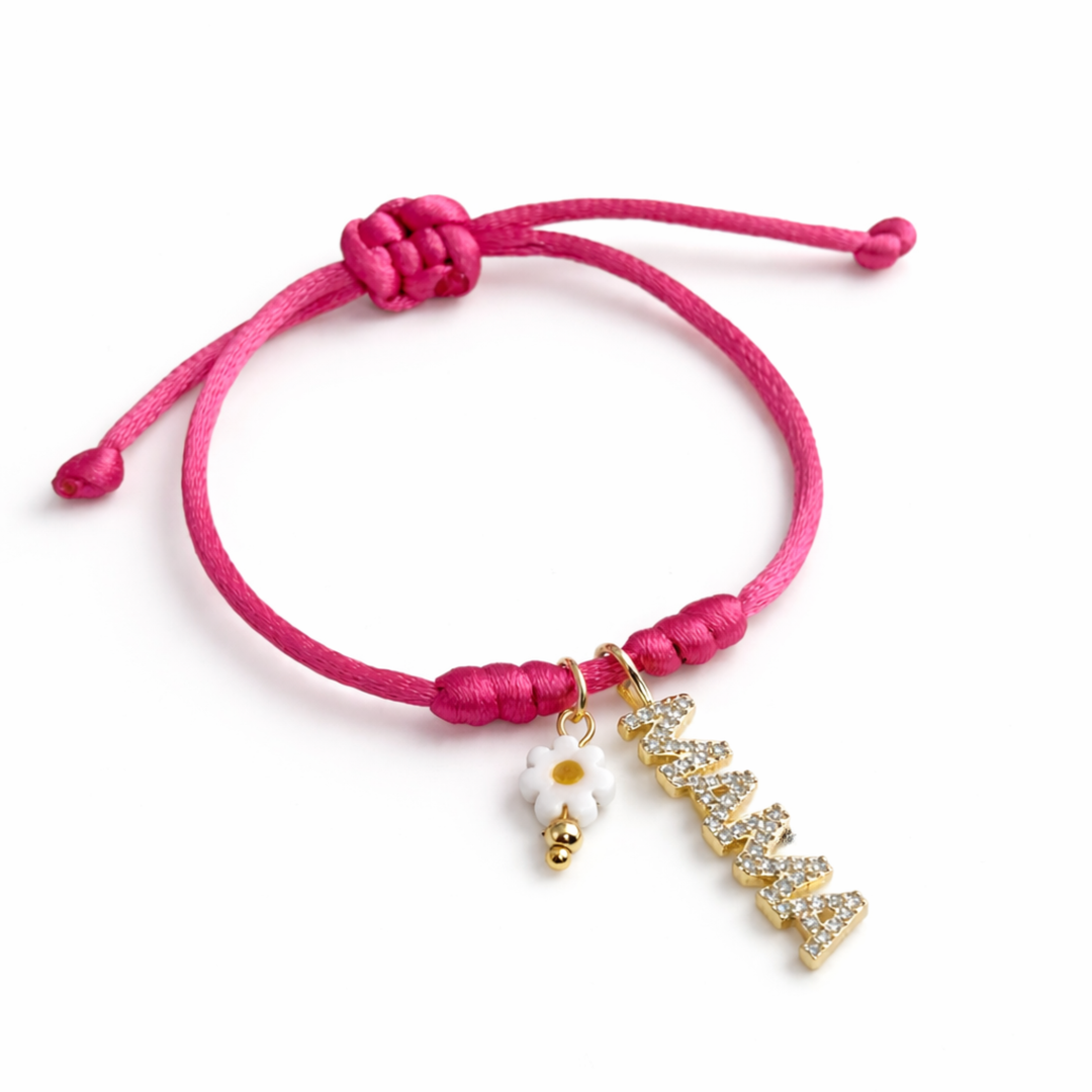 Detalles de Pulsera ajustable de hilo fucsia con dije dorado “mamá” y flor metálica de murano, vista completa.