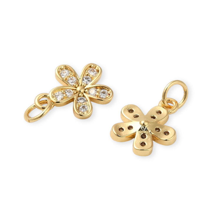 Detalles de Dije flor dorada en chapa de oro con zirconia en el centro
