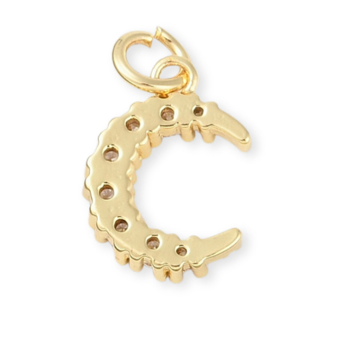 Detalles de Dije dorado en forma de luna con zirconia.