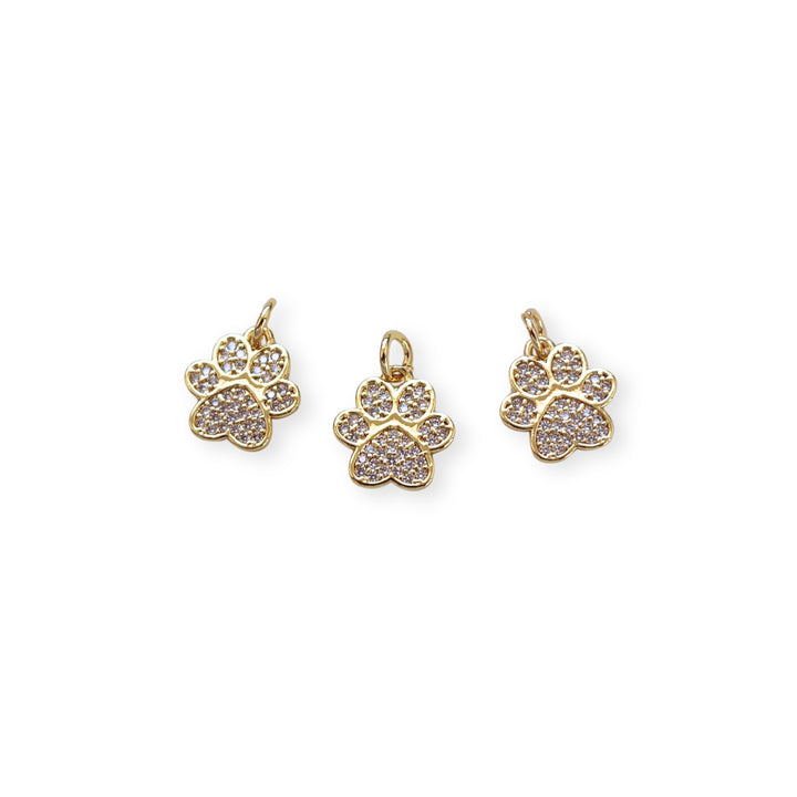 Detalles de dije huella de perro dorada con zirconia brillante