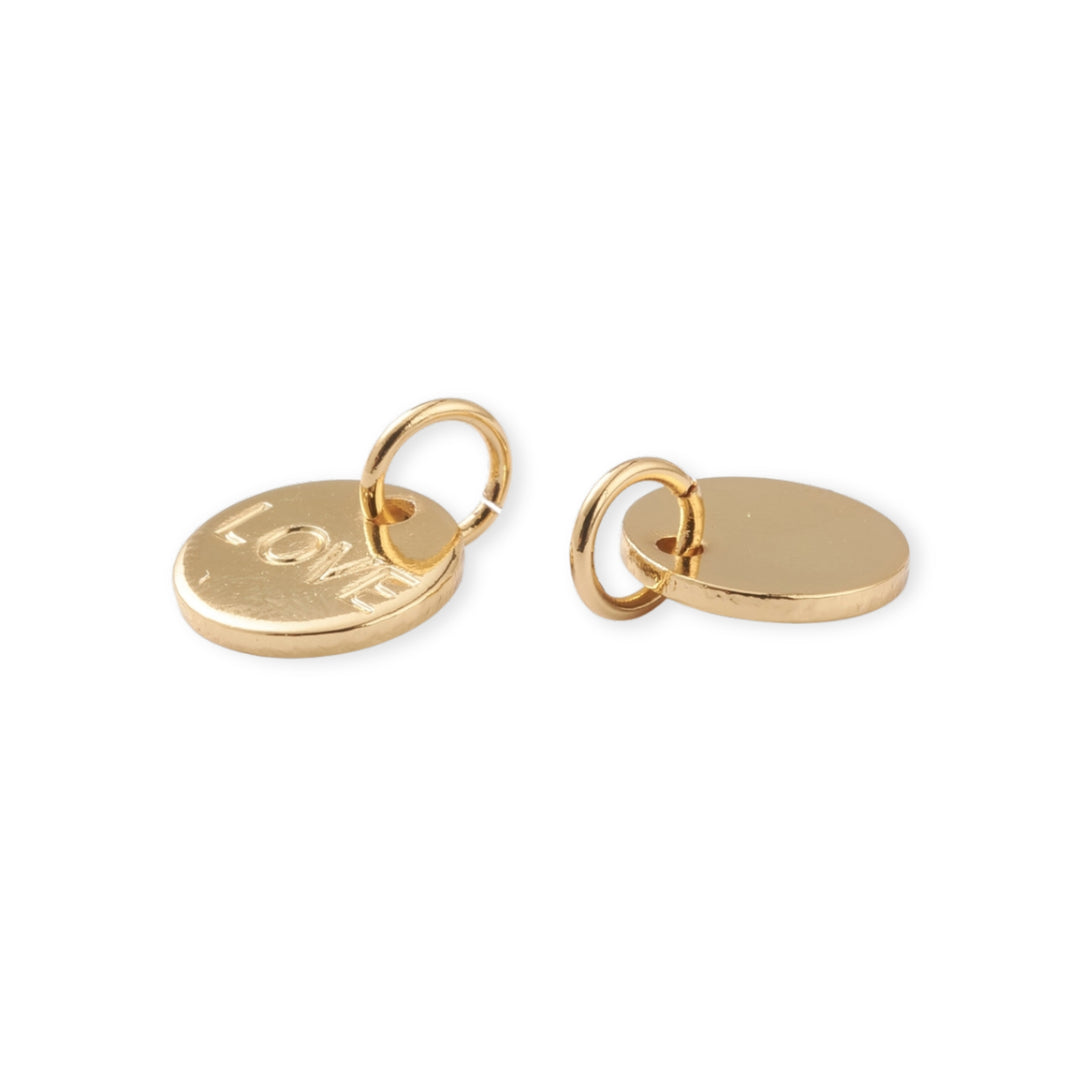 Detalles de Dije dorado circular con la palabra Love grabada al centro sobre fondo blanco