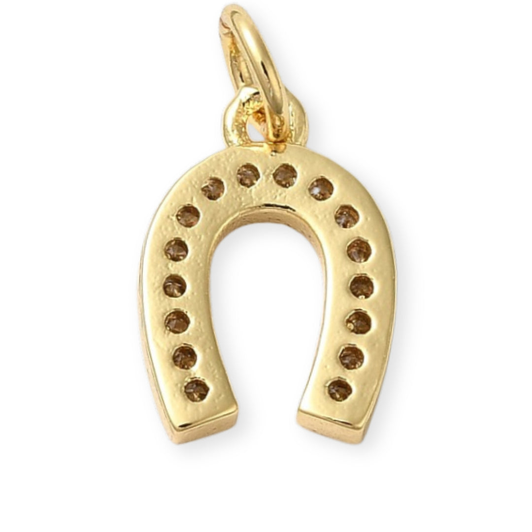 Detalles de Dije dorado en forma de herradura de caballo con zirconias