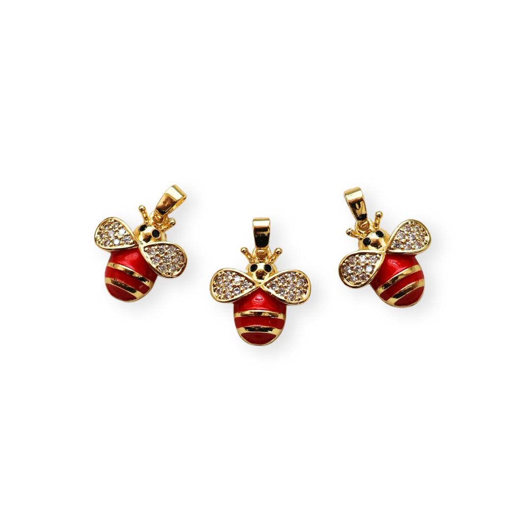 Detalles de dije dorado en forma de abeja con zirconia y esmalte en alas y cuerpo