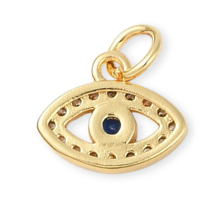 Detalles de Dije dorado en forma de ojo con zirconias y centro azul oscuro