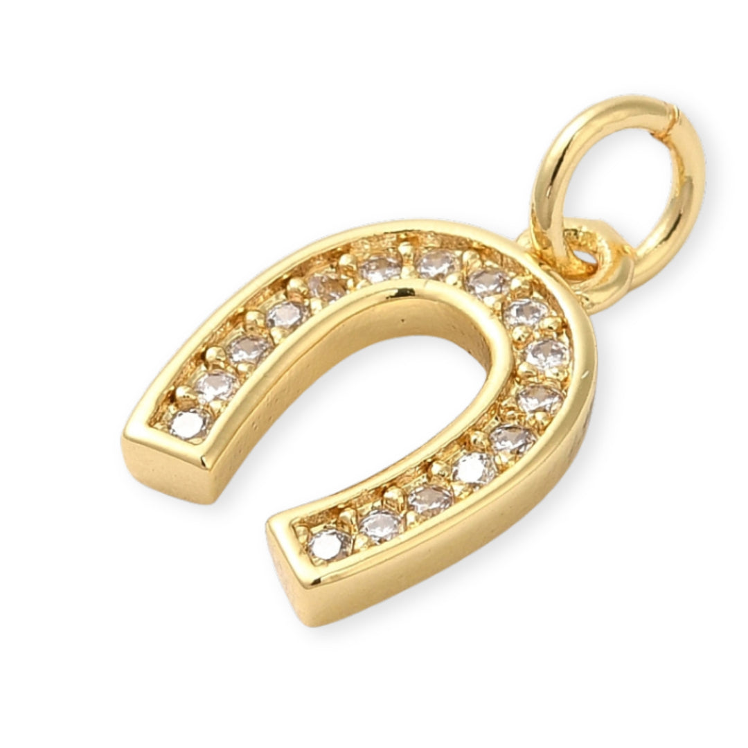 Detalles de Dije dorado en forma de herradura de caballo con zirconias