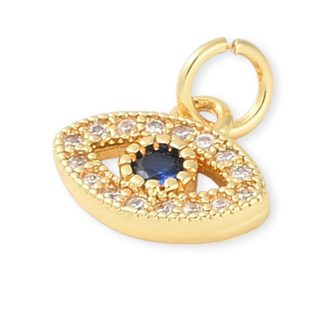 Detalles de Dije dorado en forma de ojo con zirconias y centro azul oscuro