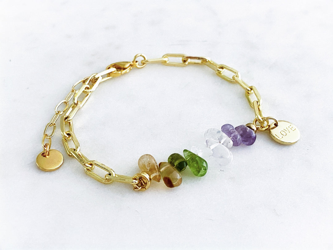 Detalle de la piedra de fluorita y la placa “Love” bañada en oro en la pulsera Cléa.