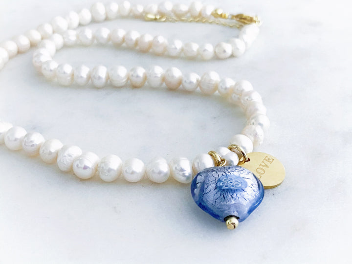 Detalle del corazón de cristal Murano y la placa dorada 'Love' del collar Élia